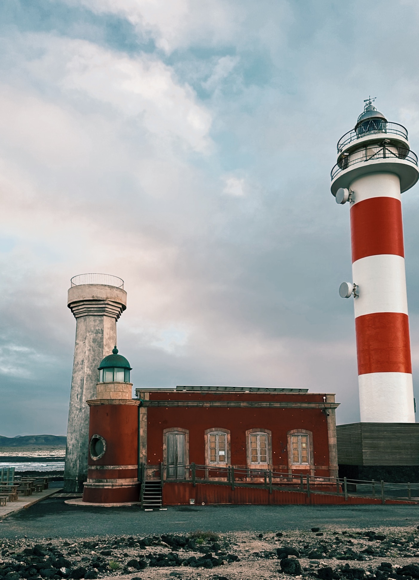 Newly built red & with light house tower next to small red traditional light house while hiking on Fuerteventura, Spain