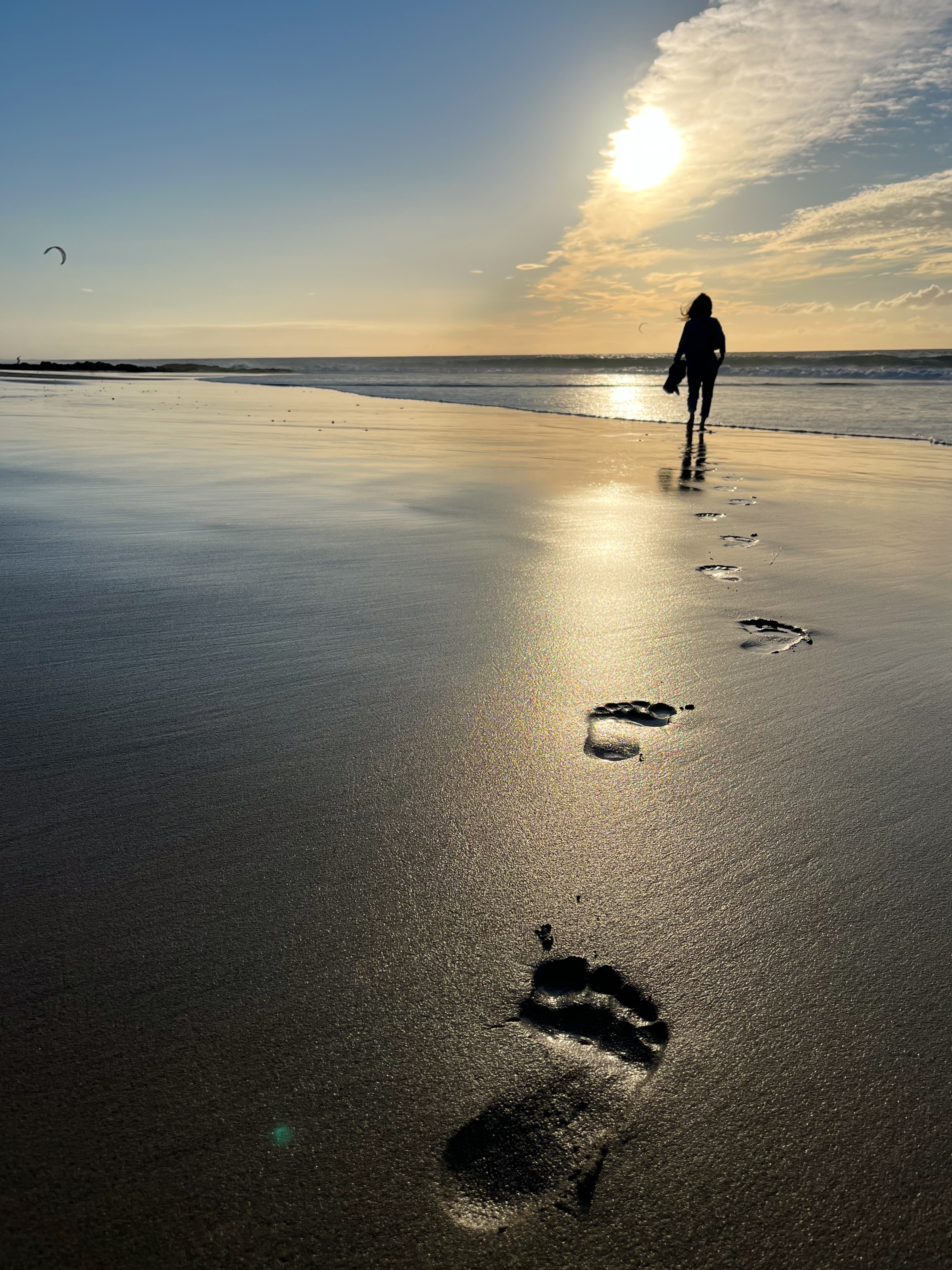 Woman walking barefoot on the best beach hiking route on Fuerteventura