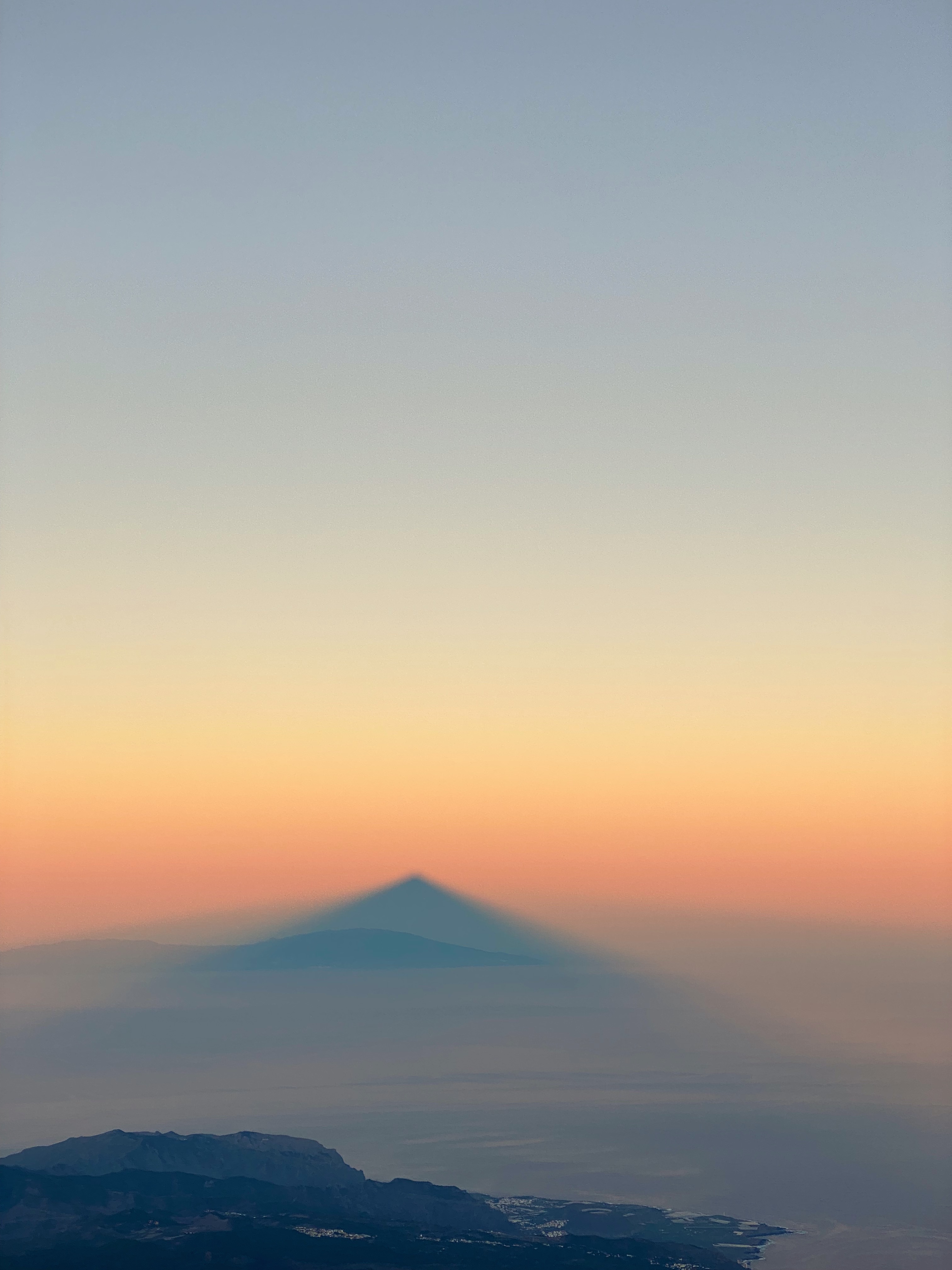 Shadow of Mount Teide cast on the sea and clouds by the sunrise