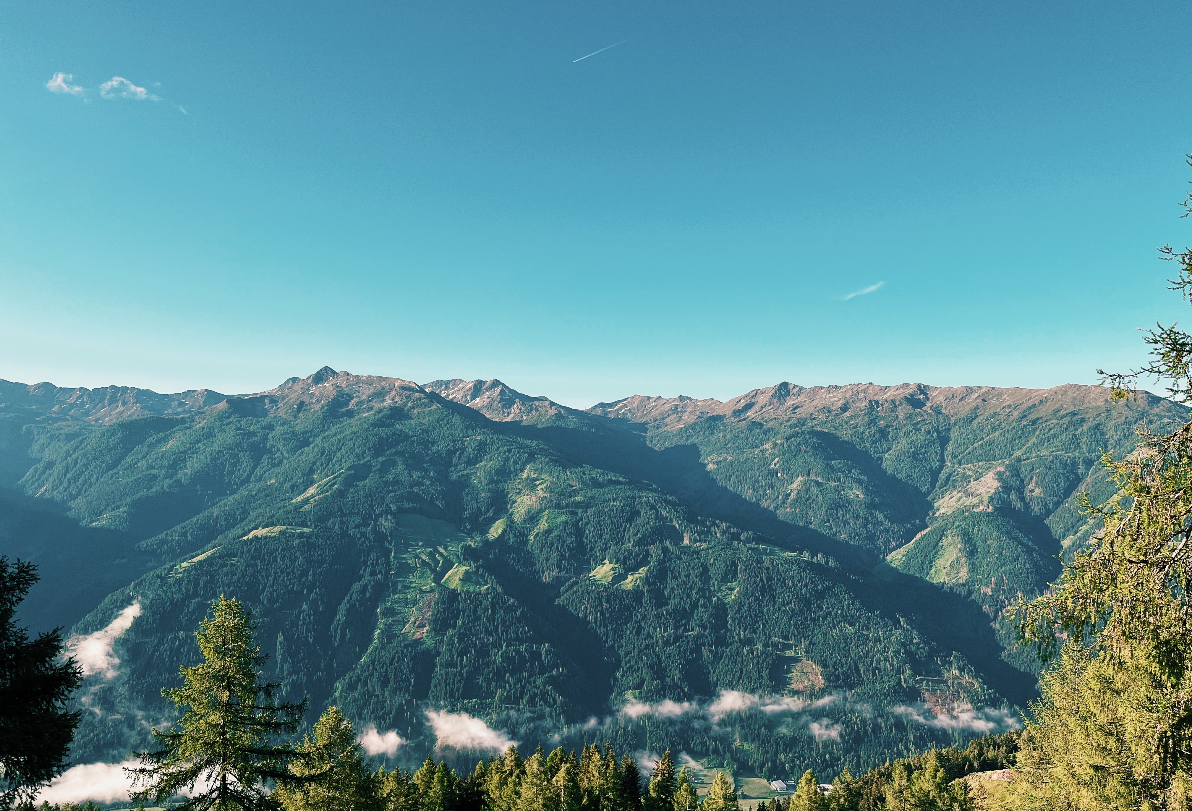 View of mountain and valley scenery from Alpengasthaus Marterle while hiking the Alpe Adria Trail