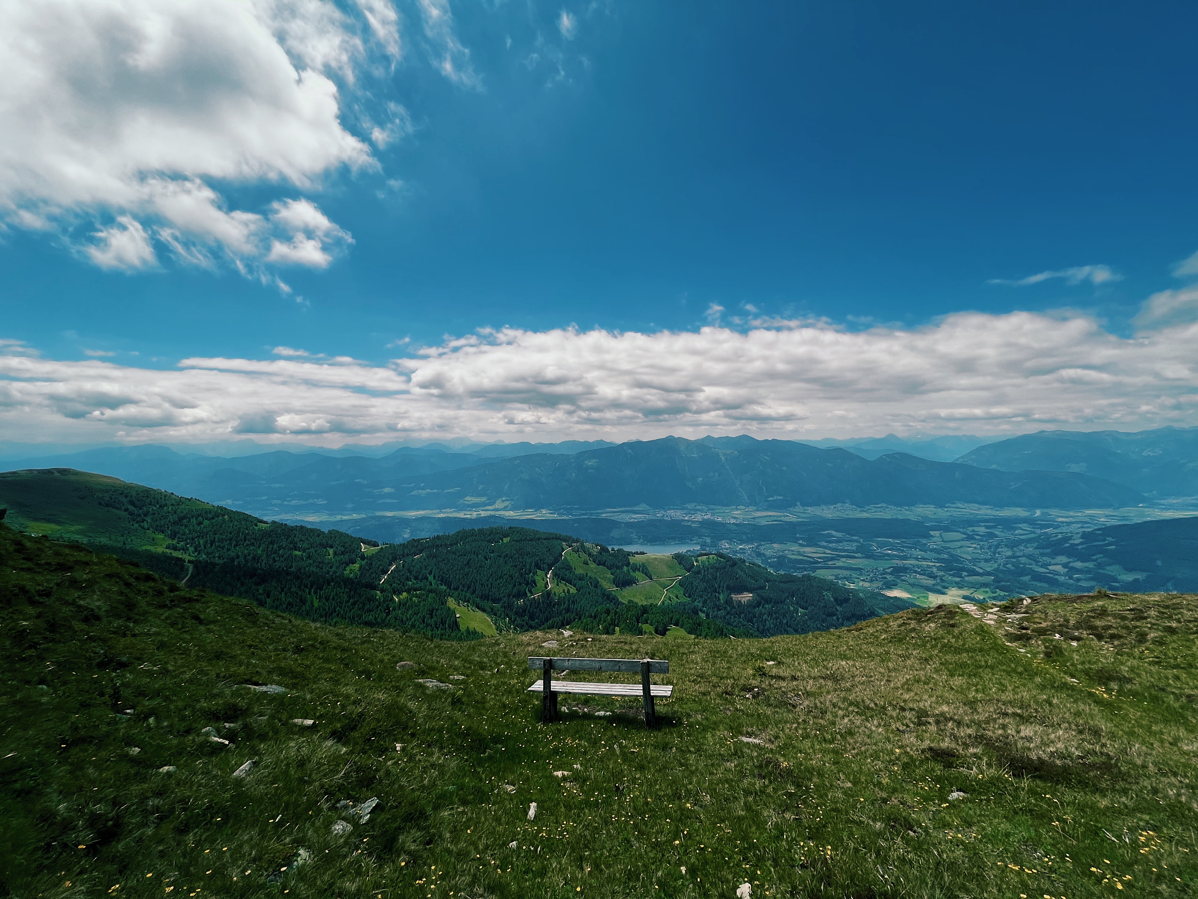 A lonely bench wit a stunning views over mountains and valeys