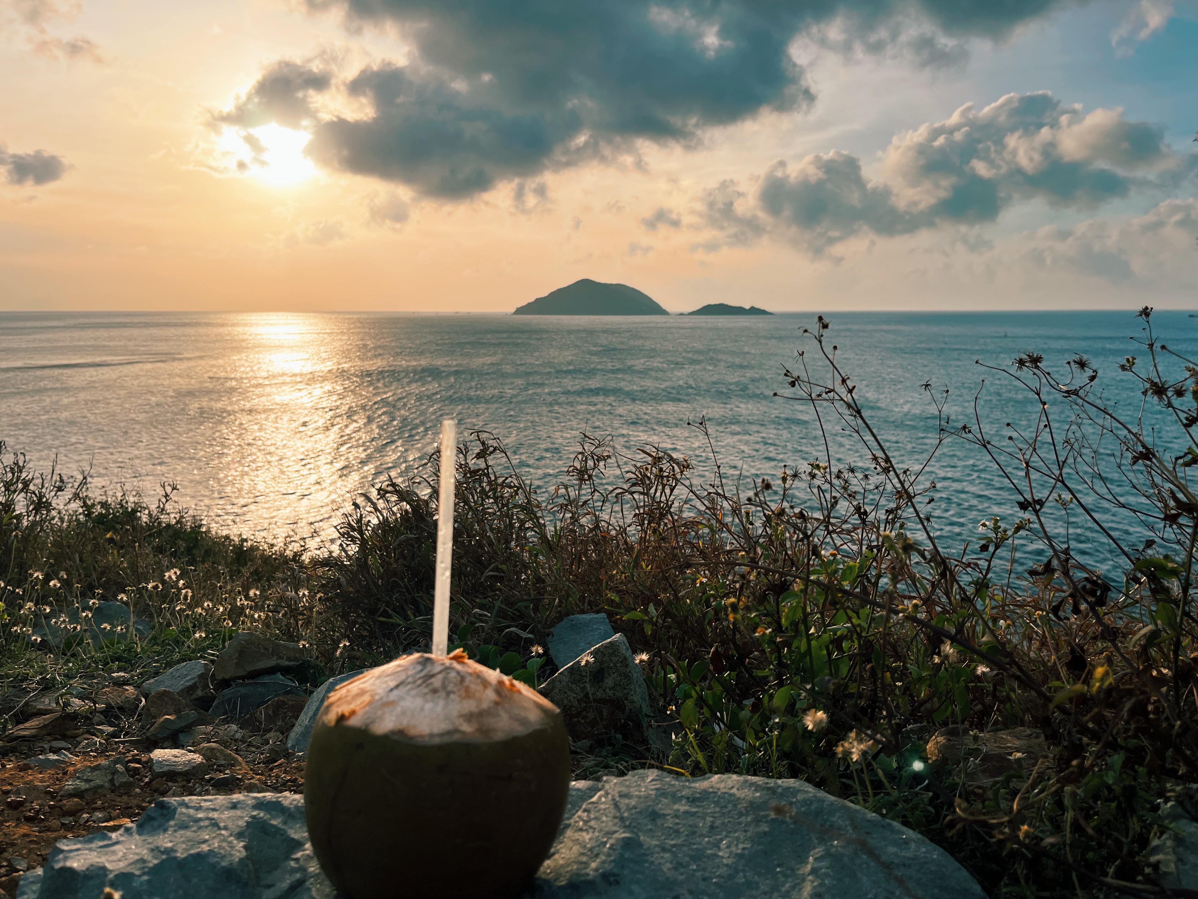 Fresh coconut water with sunset views over the sea on Con Dao Island, Vietnam